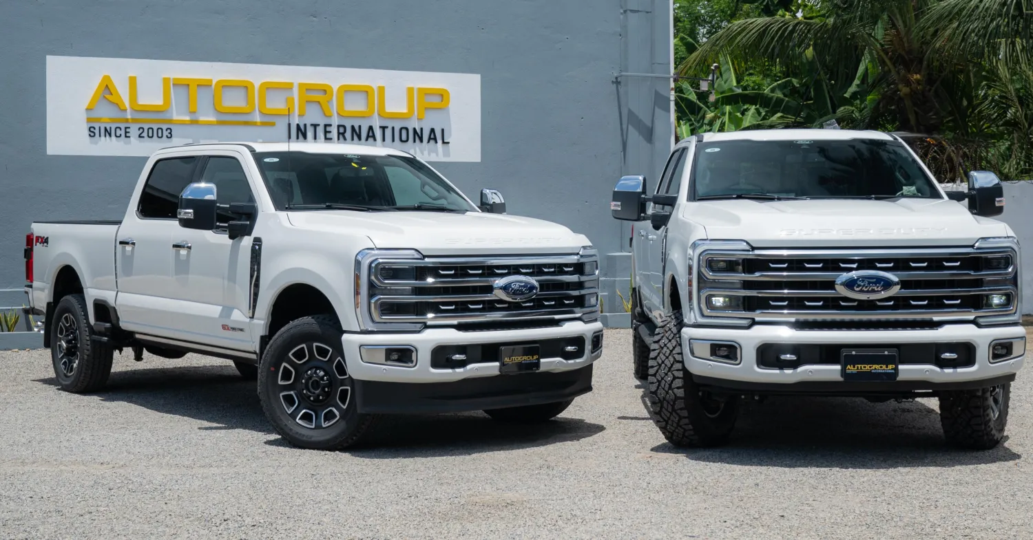 2 ford pickup trucks near sign