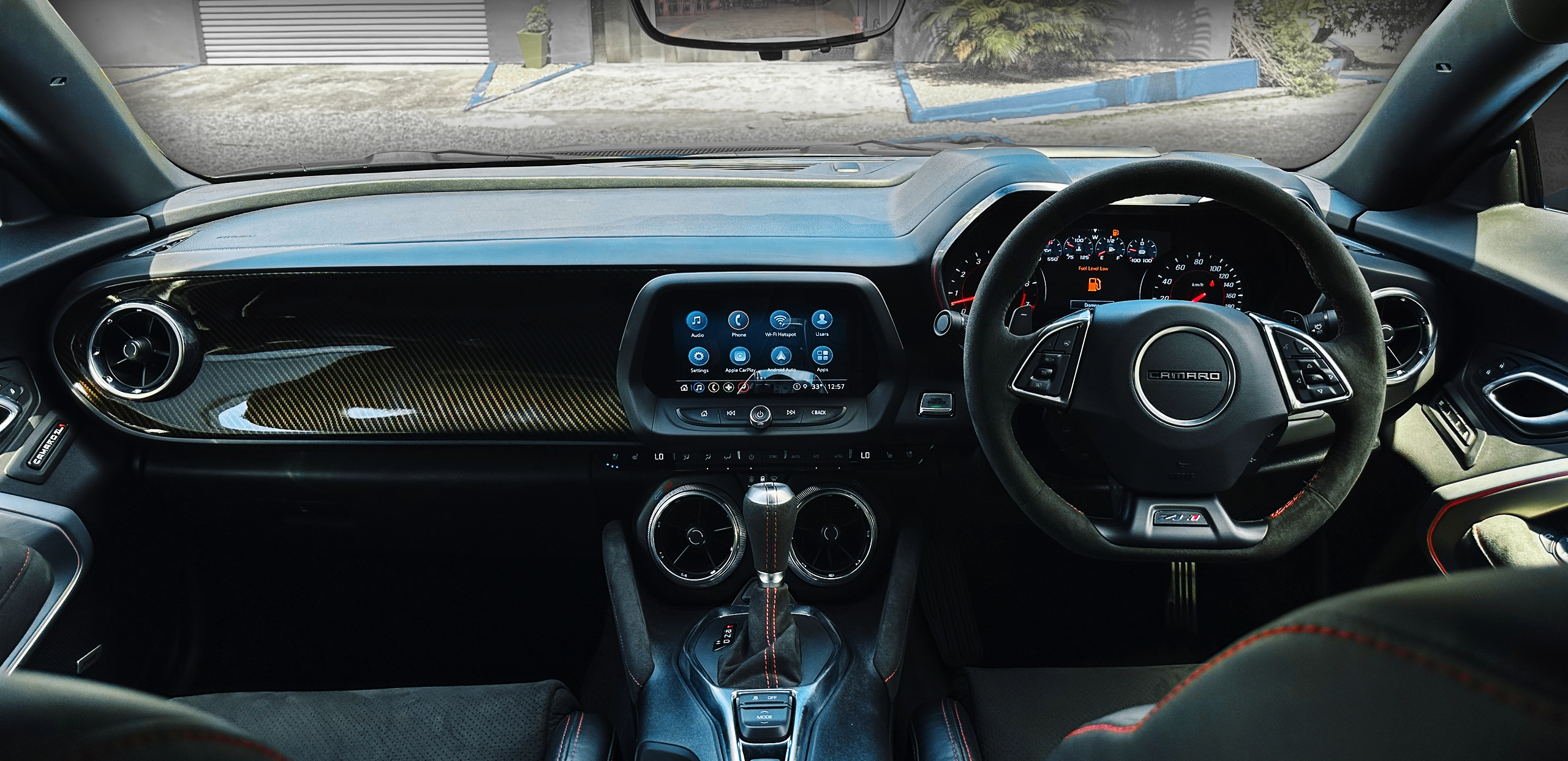 Modern car dashboard and steering wheel of a Chevrolet Camaro.