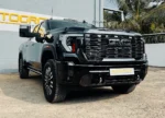 Black GMC truck parked outside Autogroup building