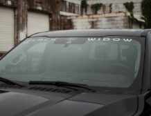 Right hand drive Black Widow F-250 Lariat Pickup truck from Autogroup International in Australia with iconic window badge