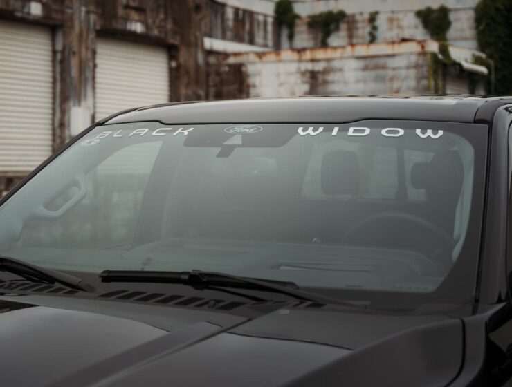 Right hand drive Black Widow F-250 Lariat Pickup truck from Autogroup International in Australia with iconic window badge