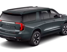 2026 GMC Yukon Denali XL AT4 Ultimate with the 6.2L V8 Petrol engine in striking Midnight Pine Metallic, featuring a premium Obsidian Rush interior with red accents and full-grain leather seating surfaces.