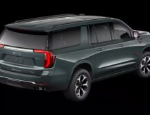 2026 GMC Yukon Denali XL AT4 Ultimate with the 6.2L V8 Petrol engine in striking Midnight Pine Metallic, featuring a premium Obsidian Rush interior with red accents and full-grain leather seating surfaces.