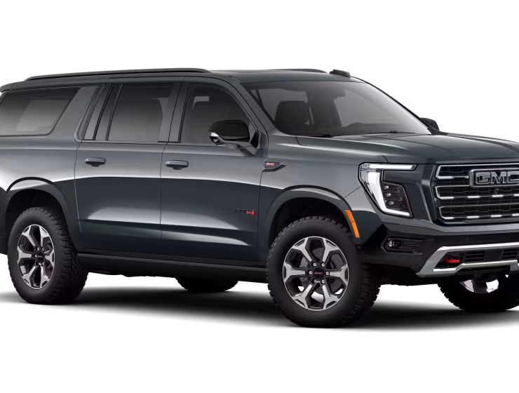 2026 GMC Yukon Denali XL AT4 Ultimate with the 6.2L V8 Petrol engine in striking Midnight Pine Metallic, featuring a premium Obsidian Rush interior with red accents and full-grain leather seating surfaces.