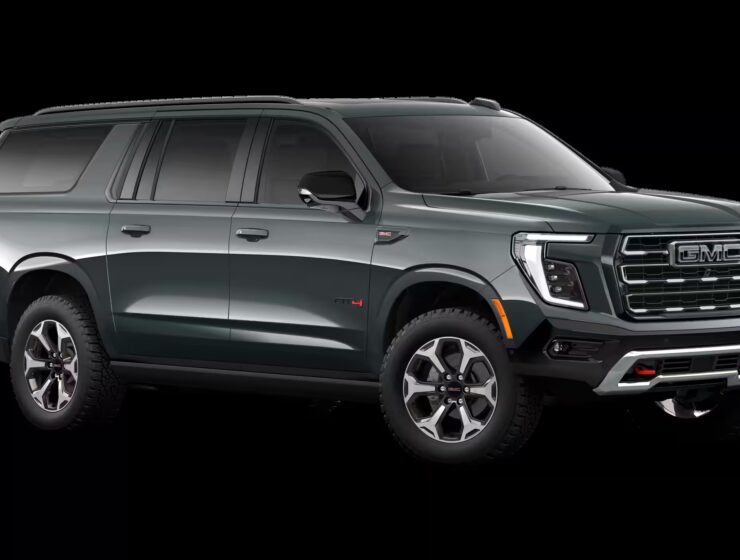 2026 GMC Yukon Denali XL AT4 Ultimate with the 6.2L V8 Petrol engine in striking Midnight Pine Metallic, featuring a premium Obsidian Rush interior with red accents and full-grain leather seating surfaces.