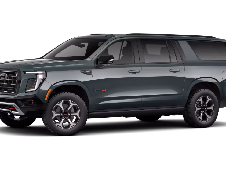 2026 GMC Yukon Denali XL AT4 Ultimate with the 6.2L V8 Petrol engine in striking Midnight Pine Metallic, featuring a premium Obsidian Rush interior with red accents and full-grain leather seating surfaces.