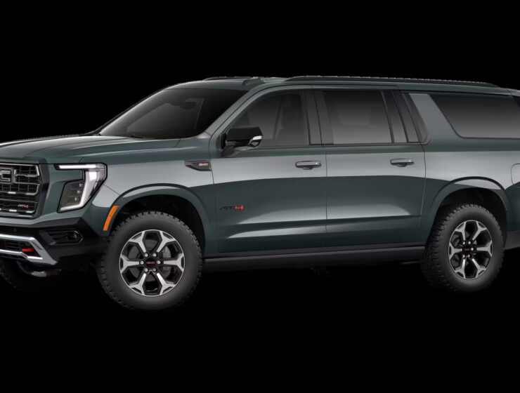 2026 GMC Yukon Denali XL AT4 Ultimate with the 6.2L V8 Petrol engine in striking Midnight Pine Metallic, featuring a premium Obsidian Rush interior with red accents and full-grain leather seating surfaces.