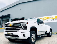 Right hand drive 2026 Chevrolet Silverado 3500 DRW High Country pickup truck from Autogroup International in Australia - front qtr view