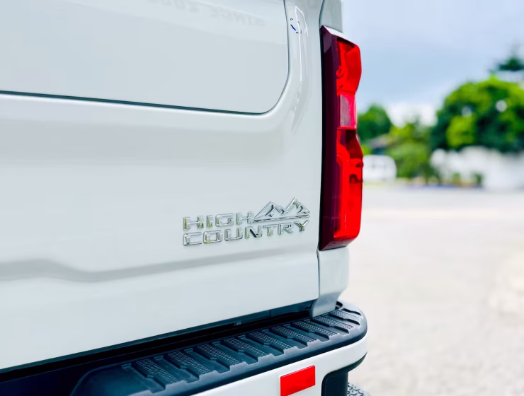 Right hand drive 2026 Chevrolet Silverado 3500 DRW High Country pickup truck from Autogroup International in Australia - High Country logo