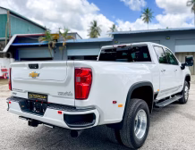 Right hand drive 2026 Chevrolet Silverado 3500 DRW High Country pickup truck from Autogroup International in Australia - rear qtr view
