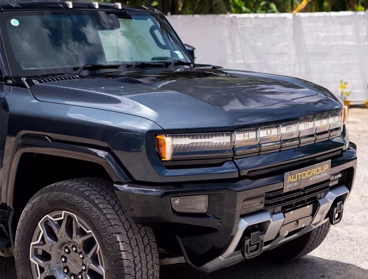 Right hand drive 2026 Hummer EV SUV 3X in Graphite Blue Metallic from Autogroup International - front quarter view